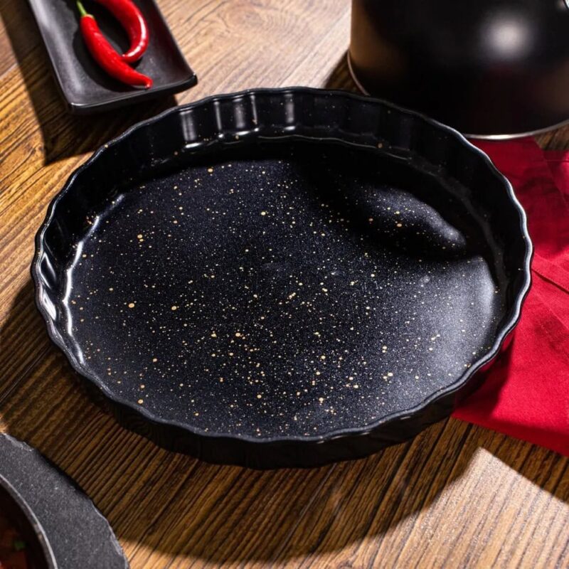 Smooth black tart pan with gold speckle design, perfect for baking exquisite desserts, cakes, and tarts, made of durable, non-stick material for easy release and cleaning, ideal for home bakers.
