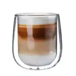 Ladny, szklany kubek z duszkiem wypełniony kawą z mlekiem i syropem czekoladowym, idealny do codziennego relaksu. Elegant, nowoczesny design, doskonały na prezent i do użytku domowego.